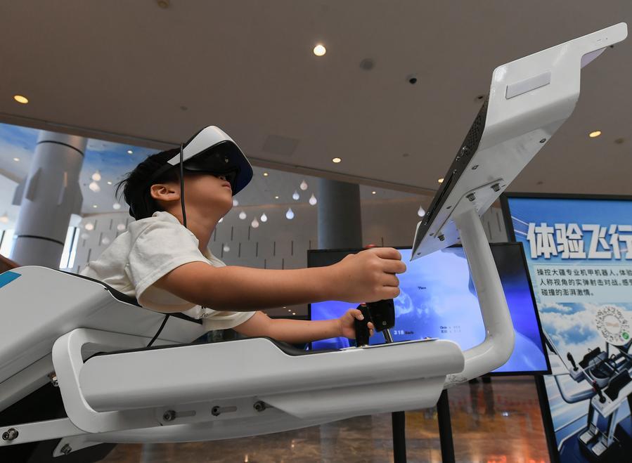 한 어린이가 6일 저장성 진화(金華)시 과학기술관에서 가상현실(VR) 안경을 쓰고 가상 비행을 체험하고 있다. (사진/신화통신)